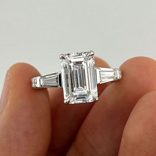 Large emerald cut diamond engagement ring in 18k white gold with tapered baguette side stones and fully pavé split shank band, custom made in Dubai UAE by Lamae Jewelry