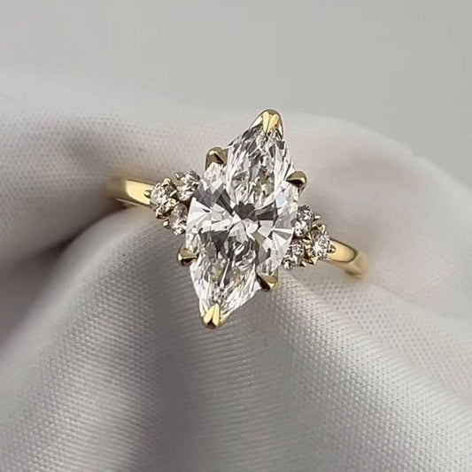 
Marquise cut diamond engagement ring in 18k yellow gold, large centre stone with round brilliant side stones on each shoulder, custom made in Dubai UAE by Lamae Jewelry