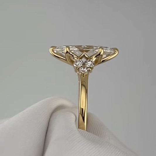 Close-up detail of custom marquise diamond engagement ring in 18k yellow gold, intricate handcrafted gold setting with floral engraving, made to order in Dubai UAE by Lamae Jewelry